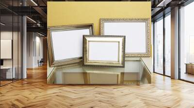 Vintage photo frames on coffee table on wallpaper background Wall mural