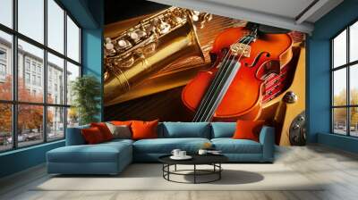 Violin and saxophone lying on piano, close up Wall mural