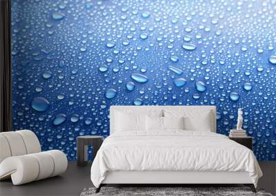 Water drops on glass on blue background Wall mural