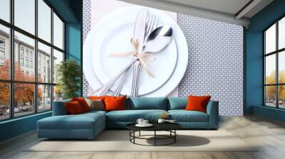 White empty plates with fork, spoon and knife tied with a ribbon Wall mural