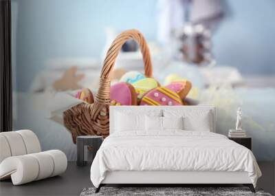 Wicker basket with tasty Easter cookies on kitchen table Wall mural