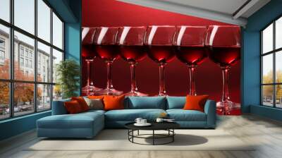 Wineglasses on red background Wall mural