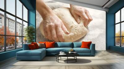 Woman kneading dough on table, closeup Wall mural