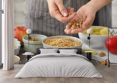 Woman preparing apple crisp on table Wall mural