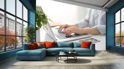 Woman working on computer at home Wall mural