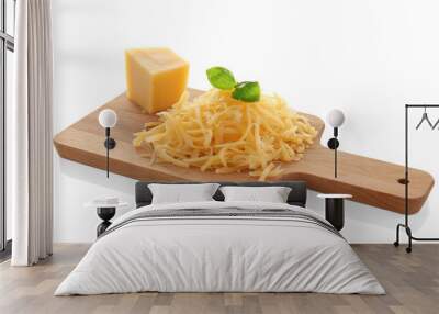 Wooden board with grated cheese on white background Wall mural