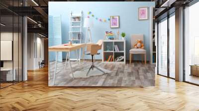 Wooden table in blue children room interior Wall mural