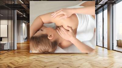 Young beautiful pregnant woman having massage in spa salon Wall mural