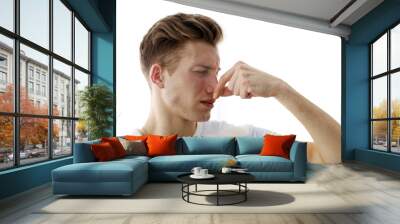 Young blonde man pinching his nose because of the stench, isolated on white Wall mural