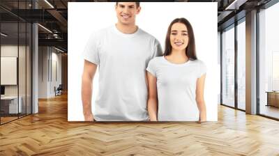 Young man and woman in stylish t-shirts on white background. Mockup for design Wall mural