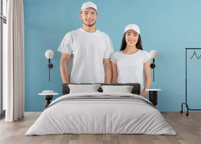 Young man and woman in stylish white t-shirts on color background. Mockup for design Wall mural