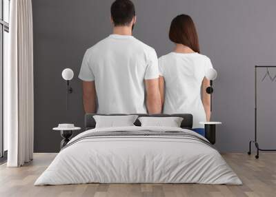 Young man and woman in stylish white t-shirts on grey background. Mockup for design Wall mural