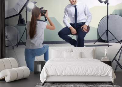 young man posing for professional photographer in studio Wall mural