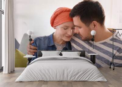 Young man visiting his wife with cancer indoors Wall mural