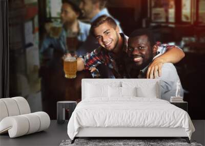 Young men drinking beer in pub Wall mural