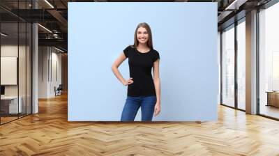 Young woman in black t-shirt on color background. Mockup for design Wall mural