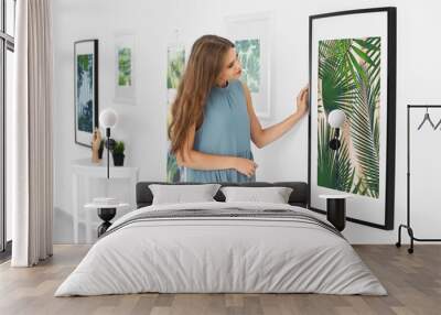 Young woman looking at picture of tropical foliage in art gallery Wall mural