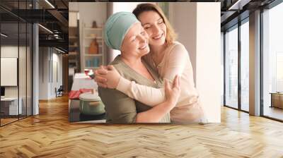 young woman visiting her mother with cancer indoors Wall mural