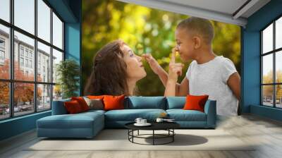 young woman with adopted african american boy outdoors Wall mural