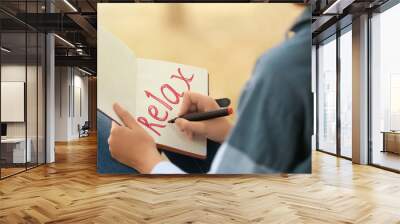 Young woman writing word 