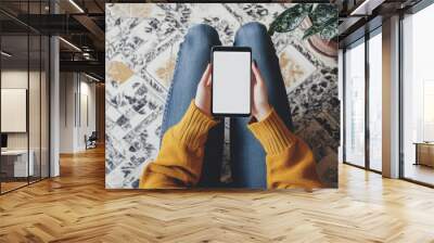 Top view Woman sitting and holding blank screen mock up mobile phone Wall mural