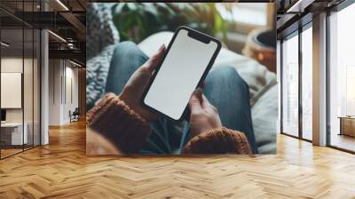 Top view Woman sitting and holding blank screen mock up mobile phone Wall mural