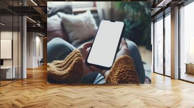 Top view Woman sitting and holding blank screen mock up mobile phone Wall mural