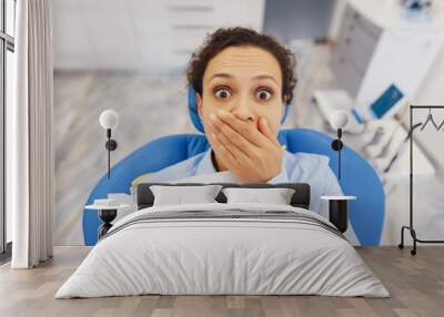 Afraid woman sitting in dental chair Wall mural