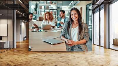 Portrait of smiling top manager standing in office and looking at camera Wall mural