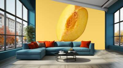 Flying fresh ripe peach with green leaves isolated Wall mural