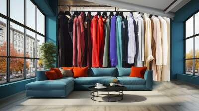 colorful clorhes on racks in a fashion boutique Wall mural