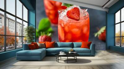 Fresh strawberry cocktail. Fresh summer cocktail with strawberry and ice cubes. Glass of strawberry soda drink on dark background. Wall mural