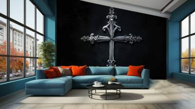 Ornate silver cross with intricate design on black Wall mural