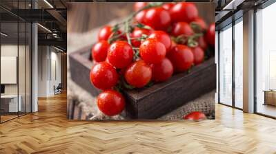 Small red cherry tomatoes on rustic background. Cherry tomatoes on the vine Wall mural