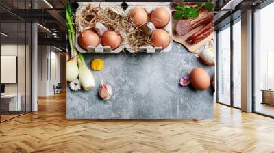 Eggs, bread, smoked sausage and vegetables. Easter food on grey, stone backround. Wall mural