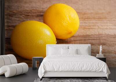 Two lemons on brown wooden table Wall mural