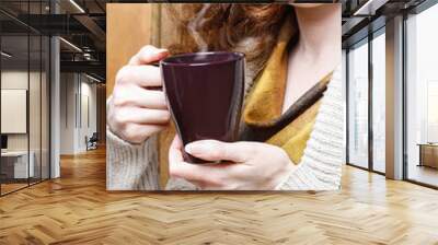 woman holding mug of hot steaming tea in her hands. selective fo Wall mural