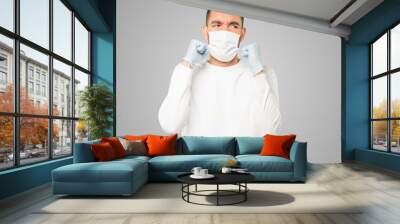 Coronavirus.Young man doing concepts and wearing mask and protective gloves Wall mural