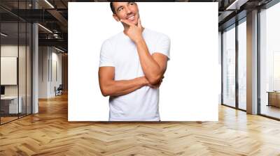 Happy young man making a gesture of doubt Wall mural