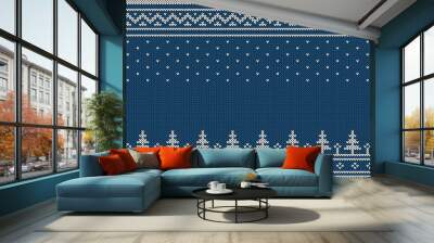 Knitted sweater ornament - spruce, falling snow, national patterns. White on a blue background. Wall mural