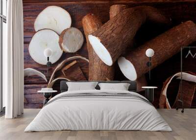 fresh cassava and peels and slices on rustic wooden table Wall mural