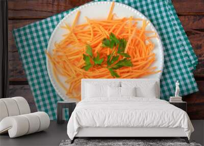 Fresh raw carrot spiralized spaghetti on white plate on rustic wooden table. Concept of healthy food Wall mural