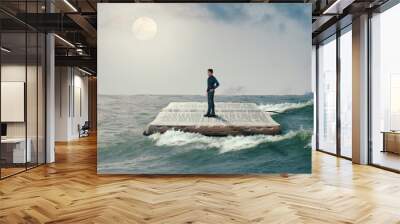 man sailing on the Holy Bible, in rough seas, seeking salvation by faith in Jesus Christ, Son of God Wall mural