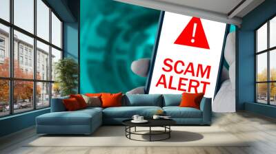 Scam Alert message on smartphone screen caused by cyber attack Wall mural