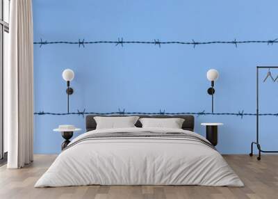 barbed wire on blue sky background Wall mural