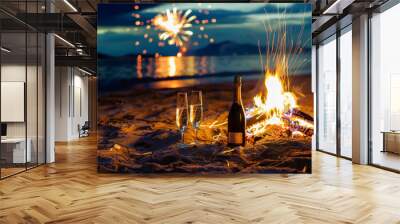 Bottle of champagne and two glasses next to a bonfire on the beach with fireworks in the sky. Concept of Noche de San Juan and summer parties on the beach. Wall mural