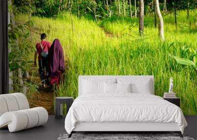 Life at a village with rice fields and activities in the village captured in the morning. Wall mural