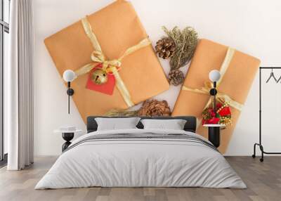 Centered kraft paper rustic gift boxes isolated on white glowing snowy background with autumn decorations: pine cones, cinnamon sticks, leaves and branches / For christmas, fall, winter and holidays Wall mural