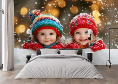 Two happy children wearing colorful winter clothes playing in snow on a winter evening Wall mural