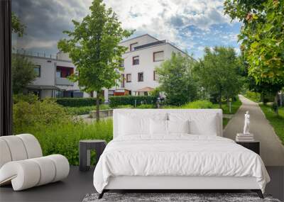 Residential area with ecological and sustainable green residential buildings, low-energy houses with apartments and green courtyard Wall mural